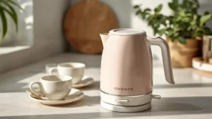 lifestyle image of an OVENTE electric kettle (1.7L) in a soft pastel color, lightweight plastic body. Cozy home kitchen setting, natural daylight