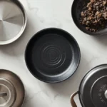 Different types of cookware including stainless steel, cast iron and non-stick pans