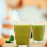 Fresh green smoothies and fruits in the kitchen, healthy breakfast