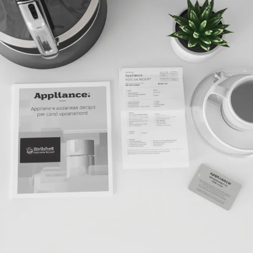 Flat lay of an appliance manual, receipt, and warranty card next to a kitchen appliance