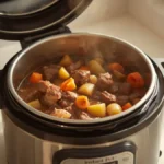 Instant Pot Pressure Cooking Times Chart: Common Foods + Conversions 3 Instant Pot pressure cooker open on kitchen counter, basket containing perfectly cooked beef stew (tender chunks of meat, carrots, potatoes), steam rising, warm home-cooked comfort food aesthetic