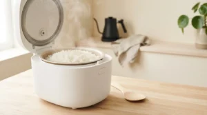 Large rice cooker filled with fluffy white rice on a bright family kitchen countertop